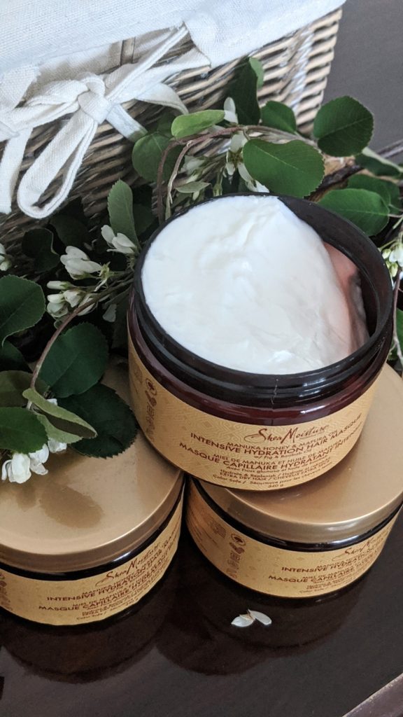 SheaMoisture Manuka Honey and Mafura Intensive Oil Hair Masque displayed reveal content inside container. Thick, white creamy consistency deep conditioning hair masque 