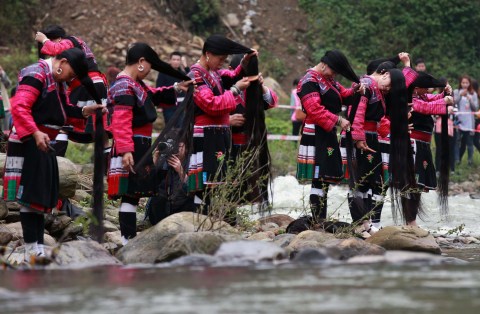 Rice water Chinese women from the Red Yao ethnic group of The Long Hair Village" washing and combing their hair