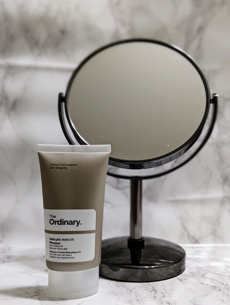 Online purchase of The Ordinary's Salicylic Acid, retailed for $12.50 CAD , Size: 1.7 oz, skincare product is displayed on marbled vanity counter with mirror in the background for decoration