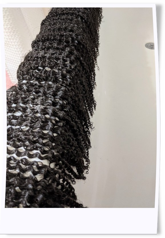 Hair Review: Amazing Beauty Hair in its washing process. This step illustrates the condition application -  letting the conditioner set in the Afro Kinky Curly clip-in extensions prior to rinse.