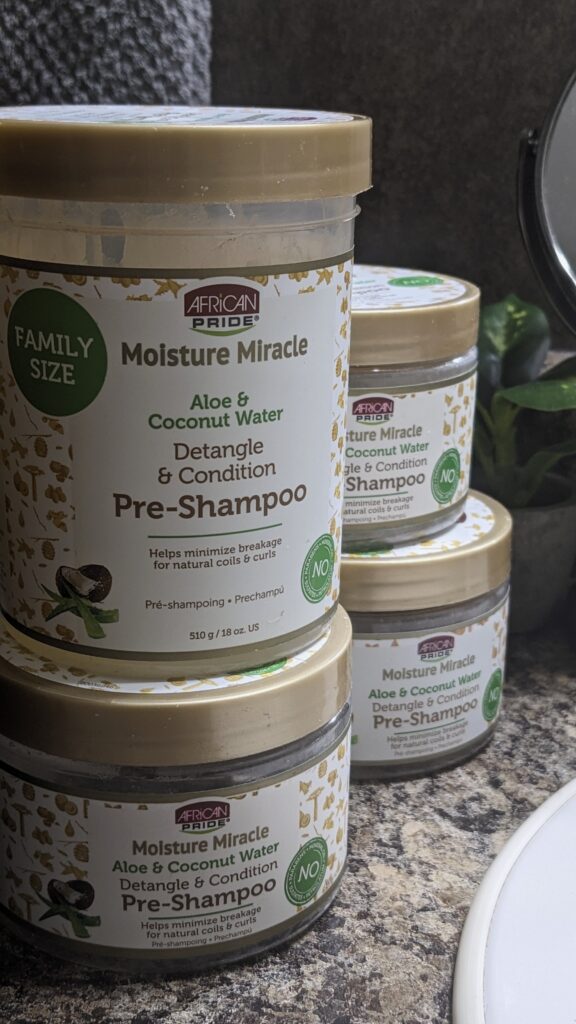 African Pride Moisture Miracle Aloe & Coconut Water Pre-Shampoo containers displayed