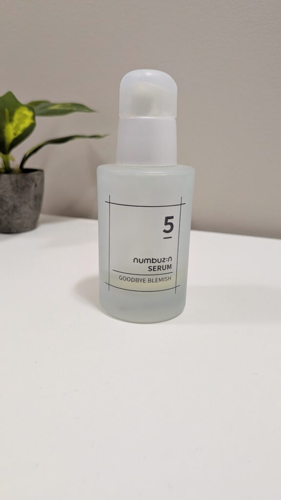 Numbuzin No.5 Goodbye Blemish Serum bottle on a bathroom vanity desk.